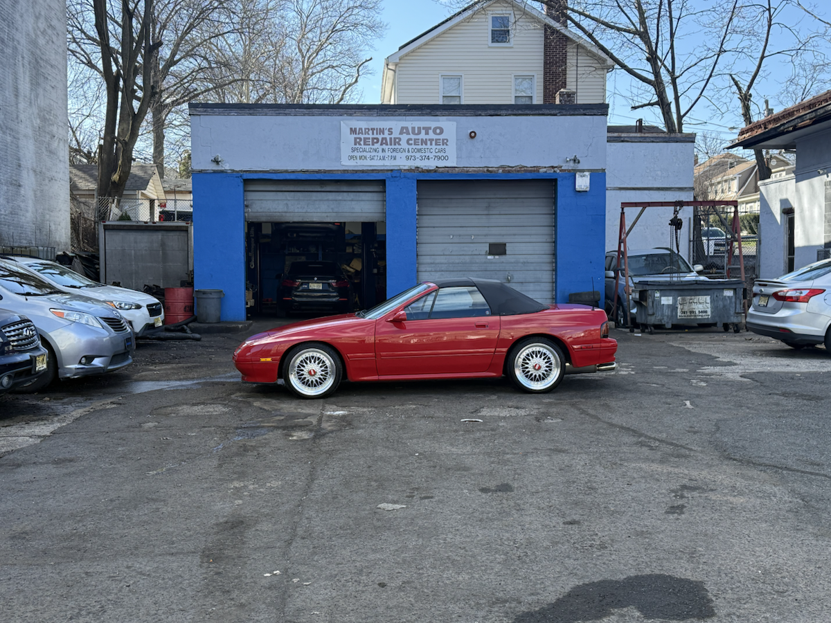 Martin's Auto Repair Center storefront with a red car parked in front